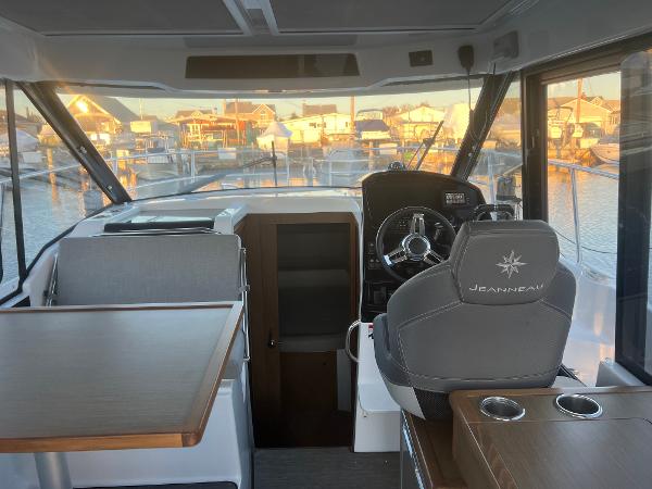 Slide: The Image of Interior of 2020 Jeanneau NC 895 boat with steering wheel and seating area. - 6