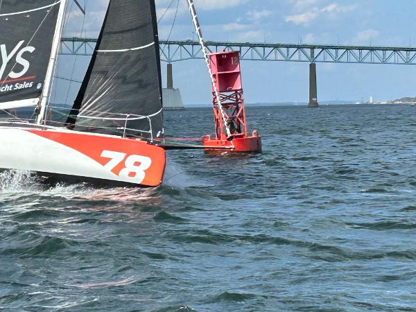 Slide: The Image of 2023 Jeanneau Sun Fast 3300 sailing near a buoy and bridge. - 1