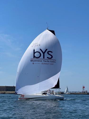Slide: The Image of 2023 Jeanneau Sun Fast 3300 sailing with large spinnaker in open water. - 6