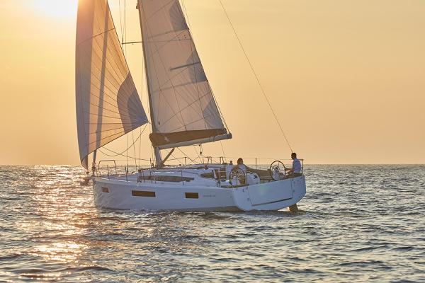 Slide: The Image of 2026 Jeanneau Sun Odyssey 410 sailing at sunset on open water. - 0