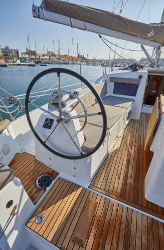 Slide: The Image of 2026 Jeanneau Sun Odyssey 410 sailboat cockpit with wooden deck and steering wheel. - 13