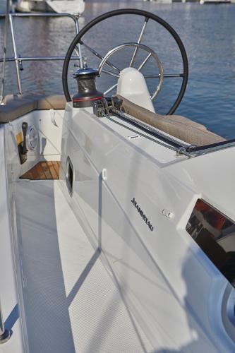 Slide: The Image of 2026 Jeanneau Sun Odyssey 410 yacht cockpit with steering wheel and winch, docked by the water. - 14