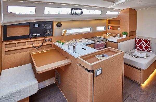 Slide: The Image of Modern interior of 2026 Jeanneau Sun Odyssey 410 yacht with sleek kitchen and seating area. - 2