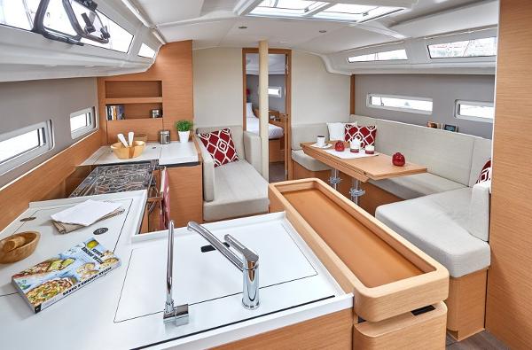 Slide: The Image of Interior of 2026 Jeanneau Sun Odyssey 410 yacht, featuring modern kitchen and cozy seating area. - 4