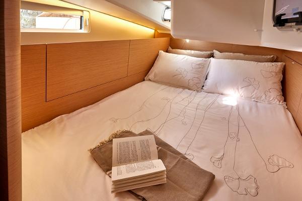 Slide: The Image of Cozy cabin interior of 2026 Jeanneau Sun Odyssey 410 with elegant bedding and natural light. - 6
