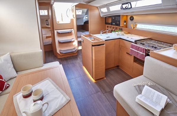 Slide: The Image of Interior of 2026 Jeanneau Sun Odyssey 410 yacht, featuring modern kitchen and cozy seating area. - 8