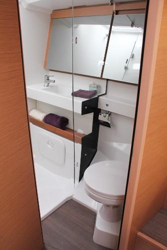 Slide: The Image of 2024 Jeanneau Sun Odyssey 440 bathroom with modern fixtures and mirrored cabinets. - 10