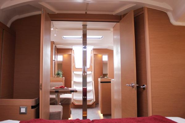 Slide: The Image of 2024 Jeanneau Sun Odyssey 440 interior, featuring modern wood finish and spacious layout. - 12