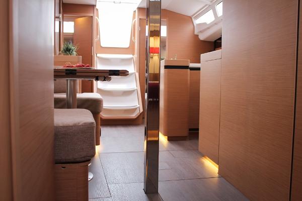 Slide: The Image of 2024 Jeanneau Sun Odyssey 440 interior with modern design and ambient lighting. - 13