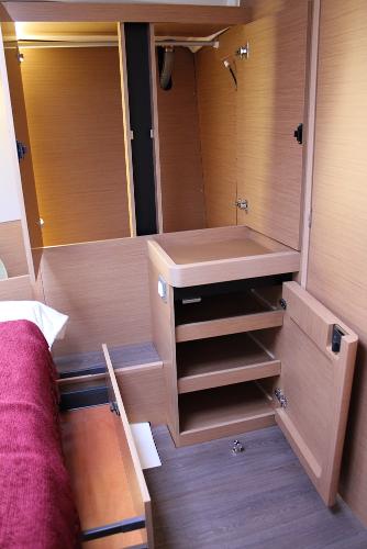 Slide: The Image of Interior of 2024 Jeanneau Sun Odyssey 440 yacht with wooden cabinetry and storage. - 14
