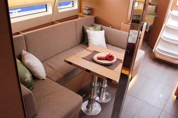 Slide: The Image of 2024 Jeanneau Sun Odyssey 440 interior with cozy seating and elegant dining area. - 15