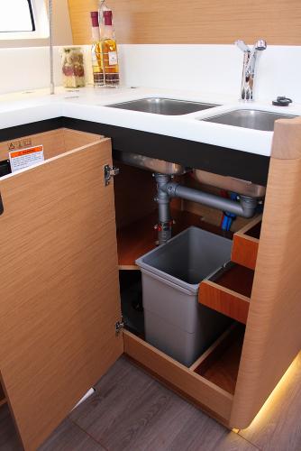 Slide: The Image of 2024 Jeanneau Sun Odyssey 440 kitchen sink area with storage and modern fixtures. - 17