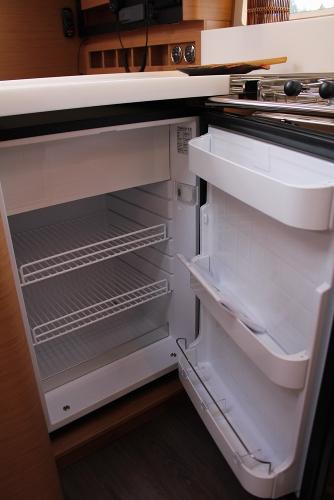 Slide: The Image of 2024 Jeanneau Sun Odyssey 440 yacht interior with open refrigerator in the galley. - 19