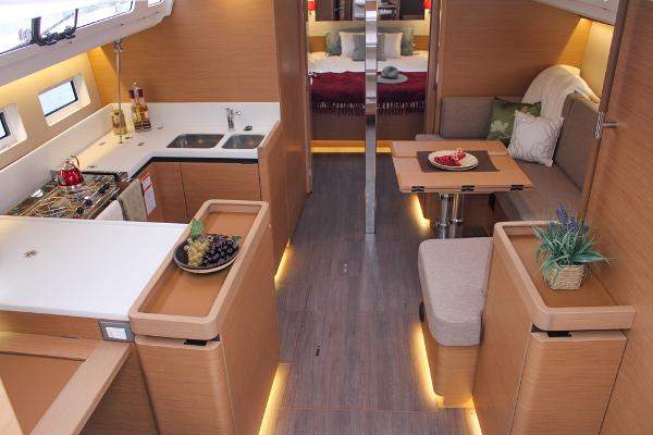 Slide: The Image of Luxurious interior of 2024 Jeanneau Sun Odyssey 440 yacht with modern kitchen and dining area. - 2