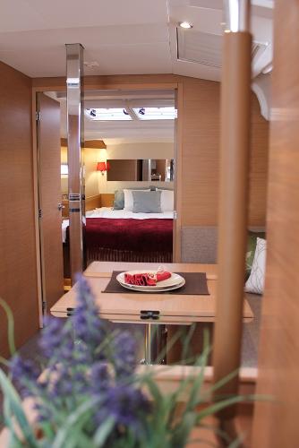 Slide: The Image of 2024 Jeanneau Sun Odyssey 440 interior with cozy cabin and elegant dining area. - 22