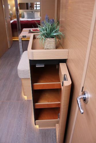 Slide: The Image of Interior of 2024 Jeanneau Sun Odyssey 440 yacht with wooden shelves and decorative plant. - 23