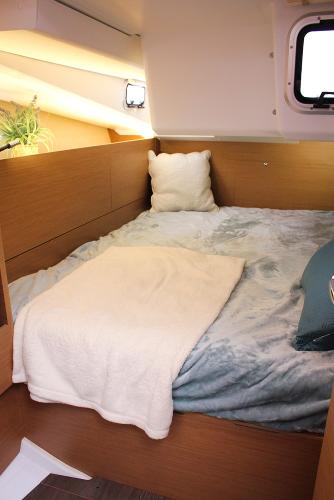 Slide: The Image of Cozy cabin interior of 2024 Jeanneau Sun Odyssey 440 sailboat with bed and window. - 26