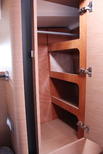 Slide: The Image of 2024 Jeanneau Sun Odyssey 440 interior closet with wooden shelves and hanging space. - 33