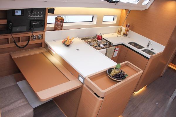 Slide: The Image of Modern kitchen interior of 2024 Jeanneau Sun Odyssey 440 yacht, featuring sleek countertops and appliances. - 4