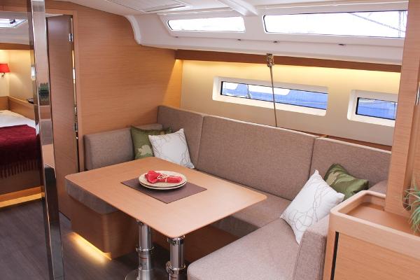 Slide: The Image of 2024 Jeanneau Sun Odyssey 440 interior with cozy seating and dining area. - 40