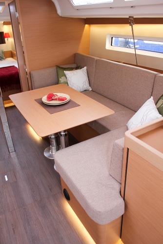 Slide: The Image of 2024 Jeanneau Sun Odyssey 440 interior with cozy seating and dining area. - 41