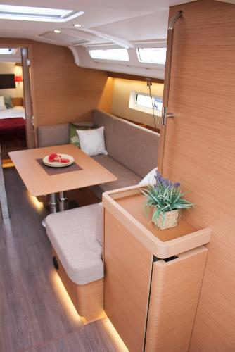 Slide: The Image of 2024 Jeanneau Sun Odyssey 440 interior with modern seating and dining area. - 43
