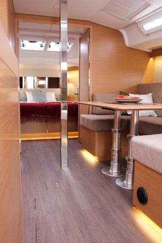 Slide: The Image of 2024 Jeanneau Sun Odyssey 440 interior with modern seating and elegant wood finishes. - 45