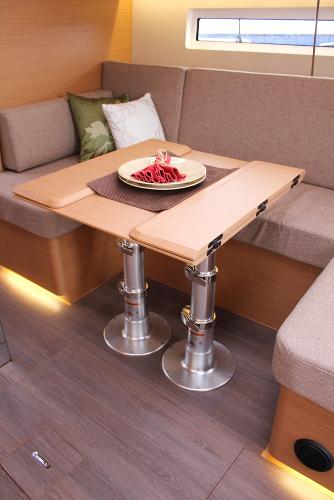 Slide: The Image of Interior of 2024 Jeanneau Sun Odyssey 440, featuring a modern dining area with adjustable table. - 48