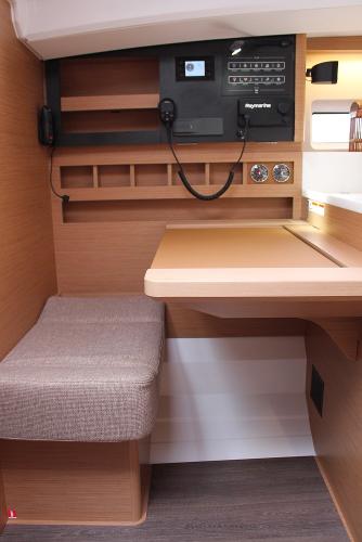 Slide: The Image of 2024 Jeanneau Sun Odyssey 440 interior with navigation station and seating area. - 6