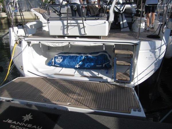 Slide: The Image of Jeanneau Yacht 65 (2025) stern view with open storage compartment and blue sail bag. - 12