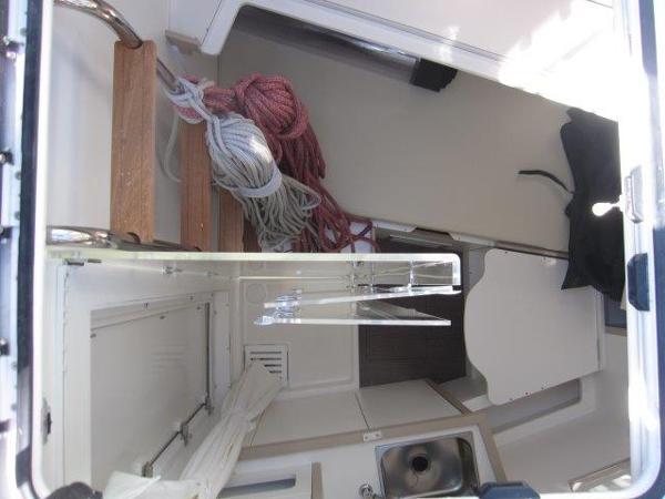 Slide: The Image of Interior of 2025 Jeanneau Yacht 65 with ropes and compact kitchen area. - 24