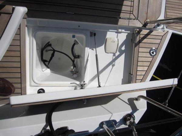 Slide: The Image of Open storage compartment on 2025 Jeanneau Yacht 65 with wooden deck. - 35