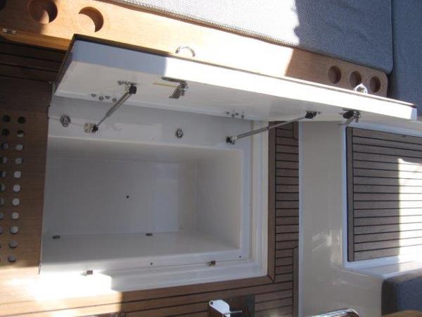 Slide: The Image of Open storage compartment on Jeanneau Yacht 65, 2025 model, with wooden deck. - 44