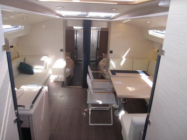 Slide: The Image of Interior of 2025 Jeanneau Yacht 65, featuring modern seating and dining area. - 46