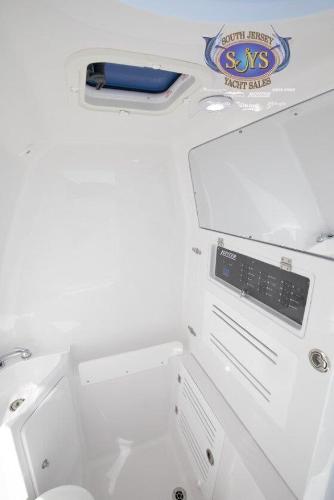 Slide: The Image of Interior cabin of 2024 Jupiter 34 boat with control panel and South Jersey Yacht Sales logo. - 10