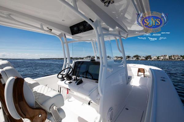 Slide: The Image of 2024 Jupiter 34 boat interior with steering wheel and navigation system. - 12