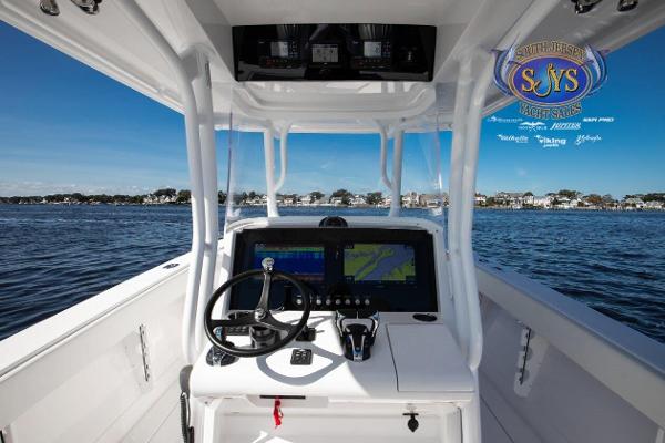 Slide: The Image of 2024 Jupiter 34 boat console with navigation system on open water. - 13