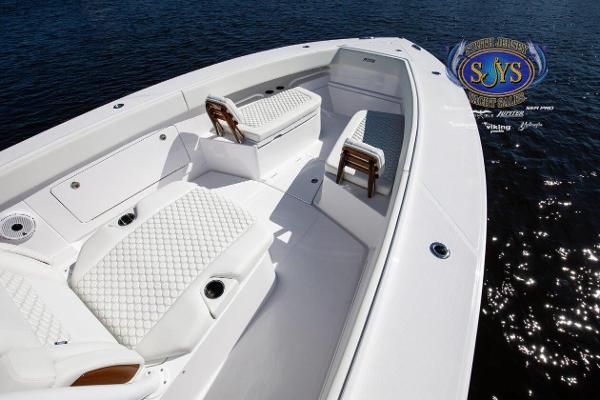 Slide: The Image of 2024 Jupiter 34 boat with white seating and diamond-pattern upholstery on water. - 14