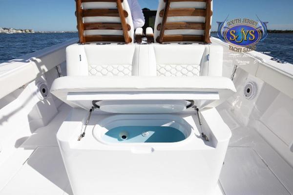 Slide: The Image of 2024 Jupiter 34 boat with open storage compartment on deck. - 23