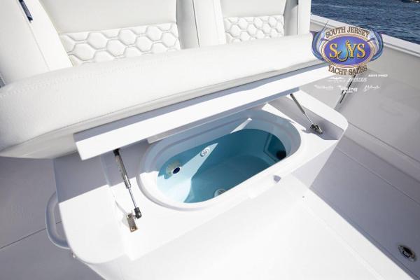 Slide: The Image of 2024 Jupiter 34 yacht with open storage compartment and South Jersey Yacht Sales logo. - 24