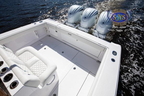 Slide: The Image of 2024 Jupiter 34 boat with triple outboard engines on water. - 25