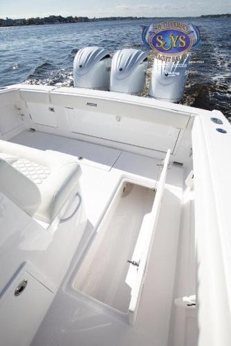 Slide: The Image of 2024 Jupiter 34 boat with triple outboard engines on open water. - 26