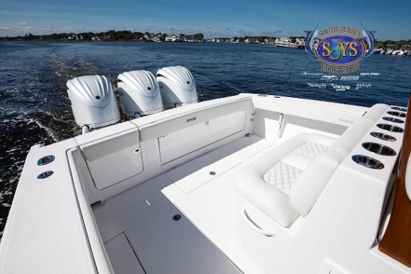 Slide: The Image of 2024 Jupiter 34 boat with triple outboard engines on a calm lake. - 27