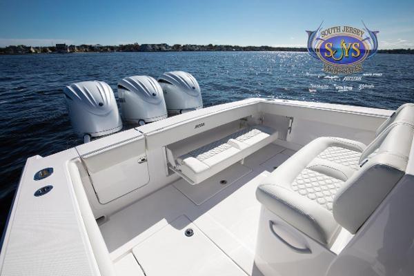 Slide: The Image of 2024 Jupiter 34 boat with triple outboard engines on calm water. - 29