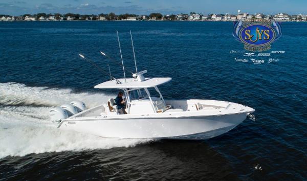 Slide: The Image of 2024 Jupiter 34 boat cruising on water, showcasing sleek design and powerful engines. - 4