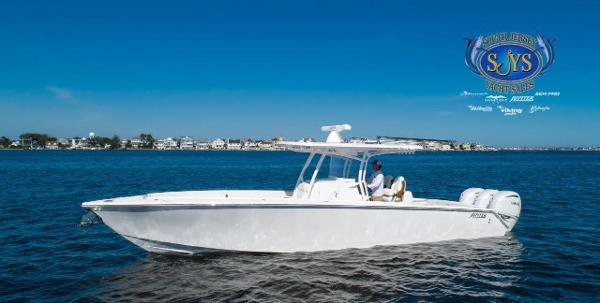 Slide: The Image of 2024 Jupiter 34 boat cruising on a sunny day with coastal town in the background. - 6