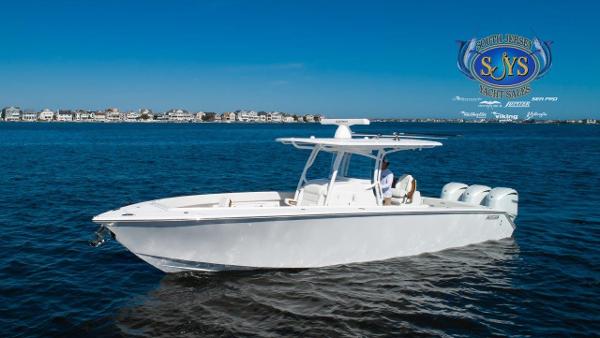 Slide: The Image of 2024 Jupiter 34 boat cruising on open water with coastal homes in the background. - 8