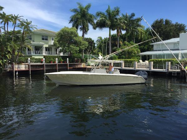 Slide: The Image of 2008 Jupiter 34 FS boat docked near waterfront homes with palm trees. - 0