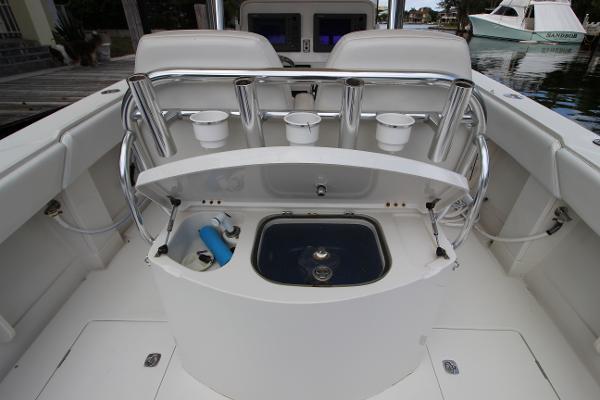 Slide: The Image of 2008 Jupiter 34 FS boat interior with fishing rod holders and livewell. - 12