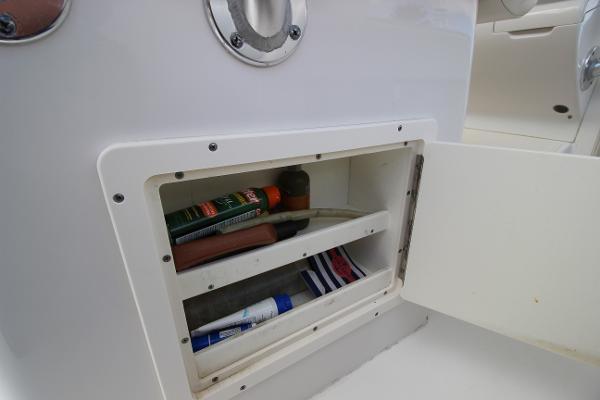 Slide: The Image of Storage compartment on a 2008 Jupiter 34 FS boat with various items inside. - 13